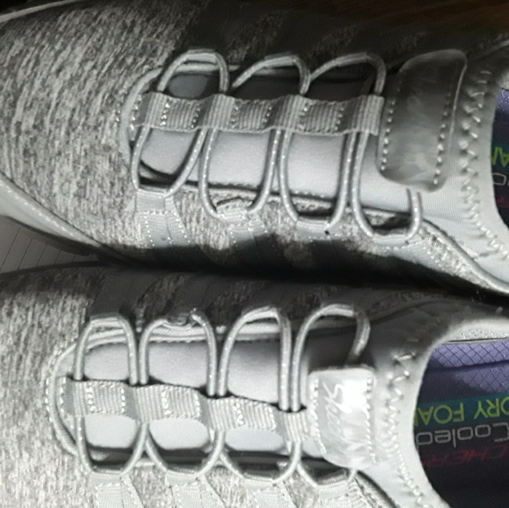Sketchers Sneakers grey in color .